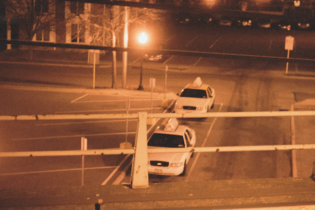 A professional taxi car parked on a quiet Valencia street at sunset.
