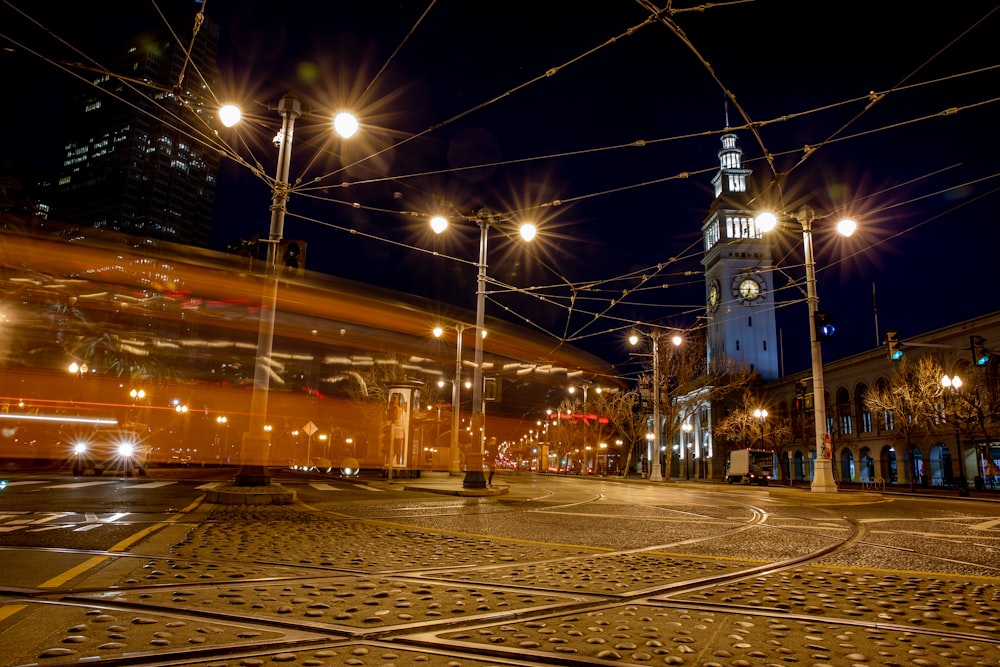 lighted outdoor lamp post near buildings at night