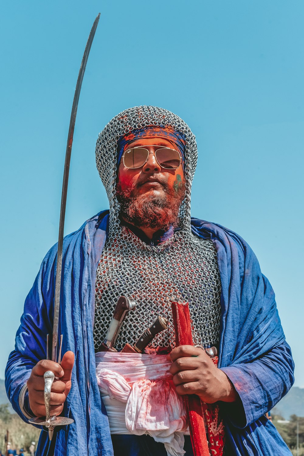 man holding sword with sunglasses