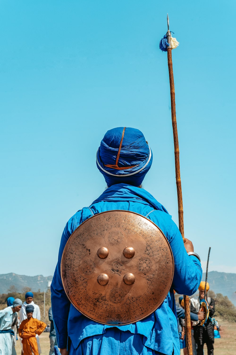 man standing while holding brown stick