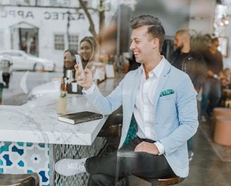 smiling man while holding smartphone