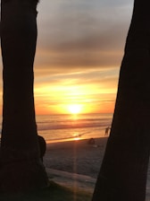 A beautiful sunset over the beach at Buenavista, Los Cabos, setting a romantic wedding scene.