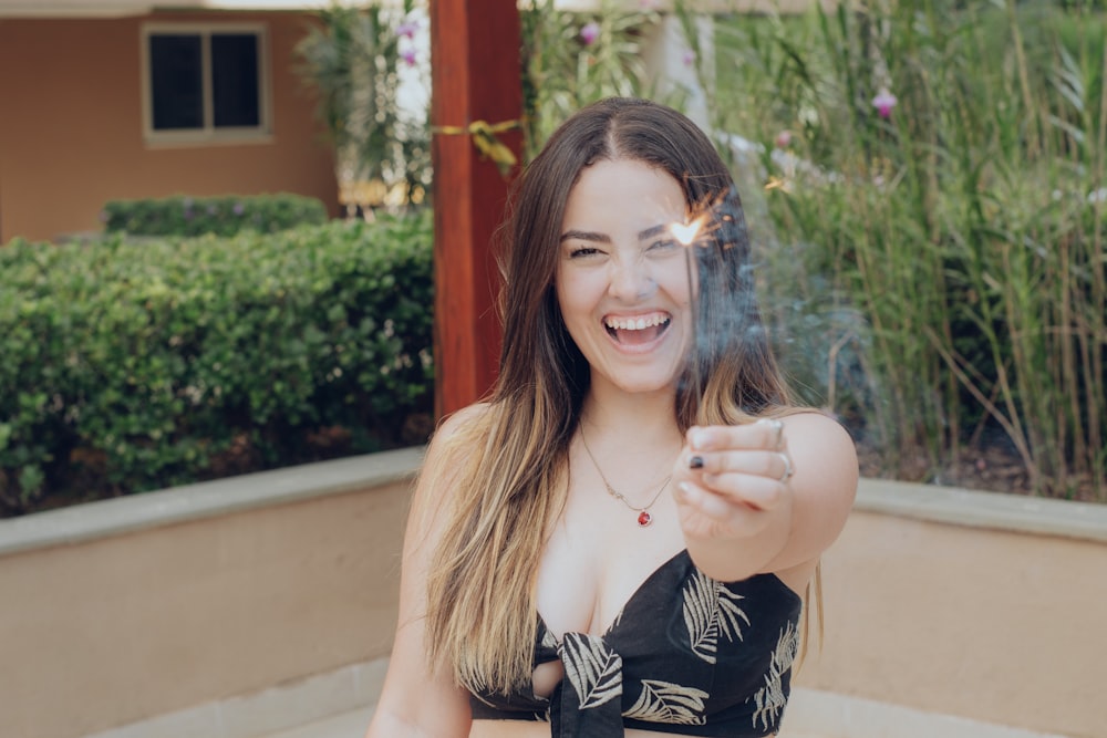 smiling woman holding sparkler