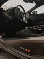 Interior shot of a McLaren 720S showing the luxurious cockpit and steering wheel.