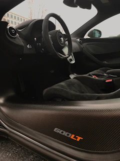 Interior shot of a McLaren 720S showing the luxurious cockpit and steering wheel.
