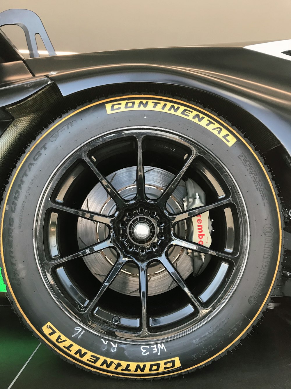 black multi-spoke vehicle wheel and Continental tire