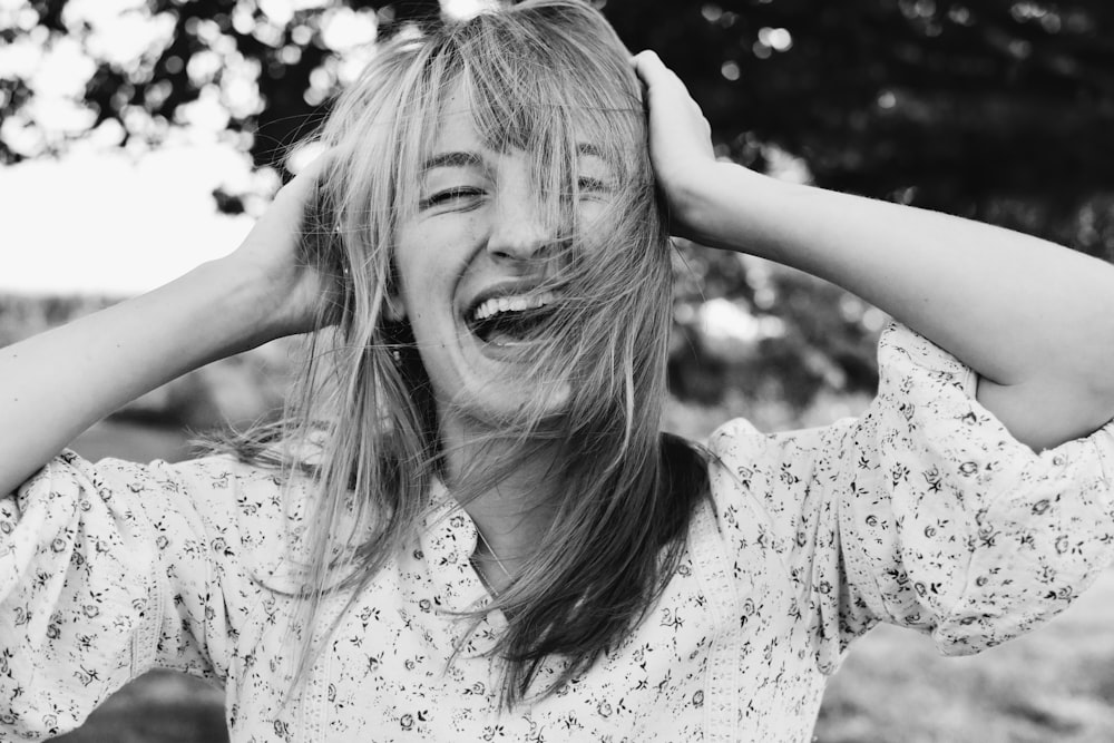 a woman with her hands on her head