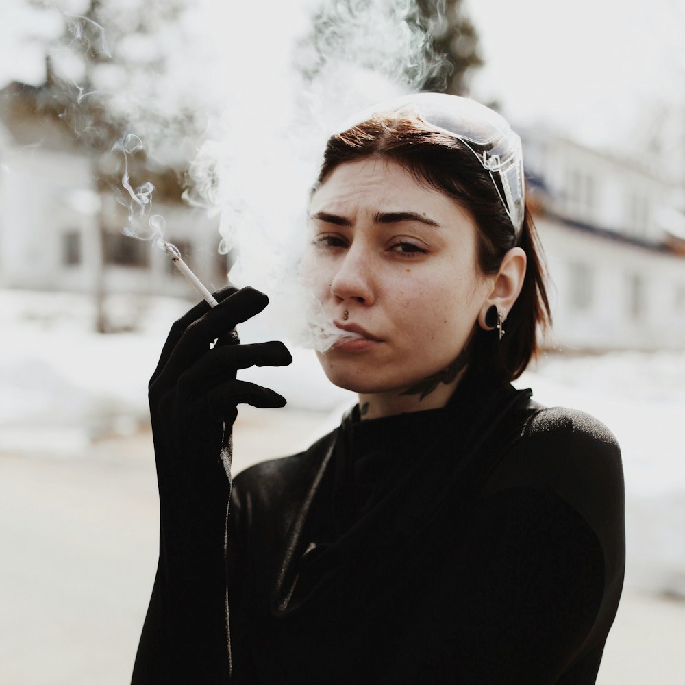 selective focus photography of smoking woman