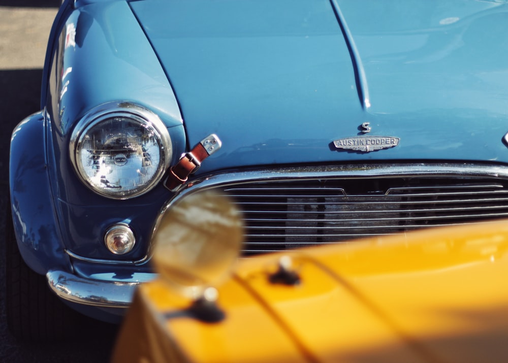 blue vehicle in front of yellow vehicle