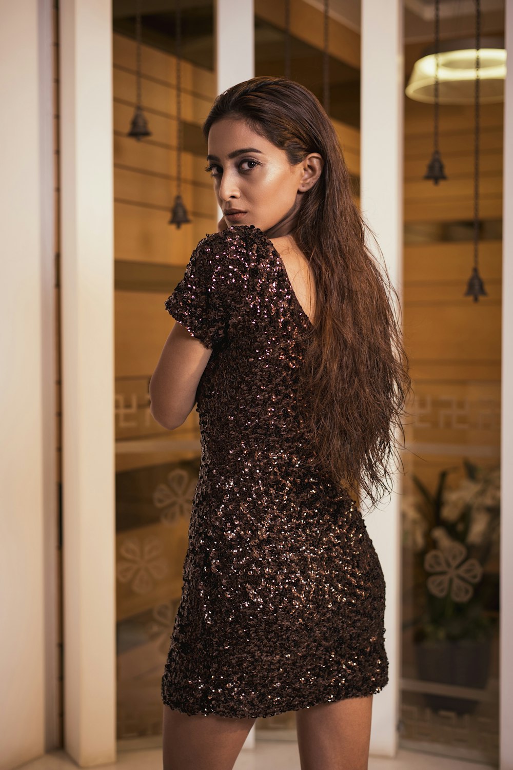 woman standing near glass door