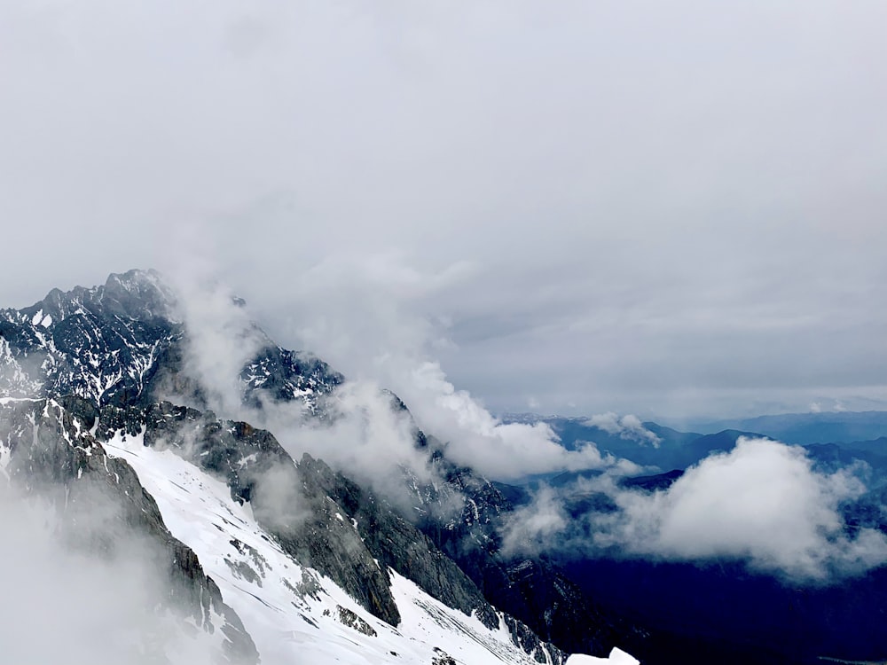 black rocky mountain with white clouds during daytime