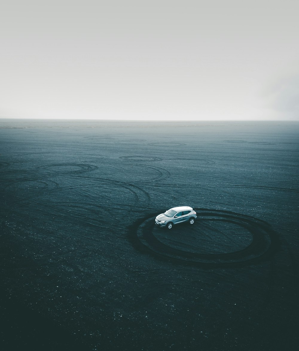 gray vehicle on gray sand