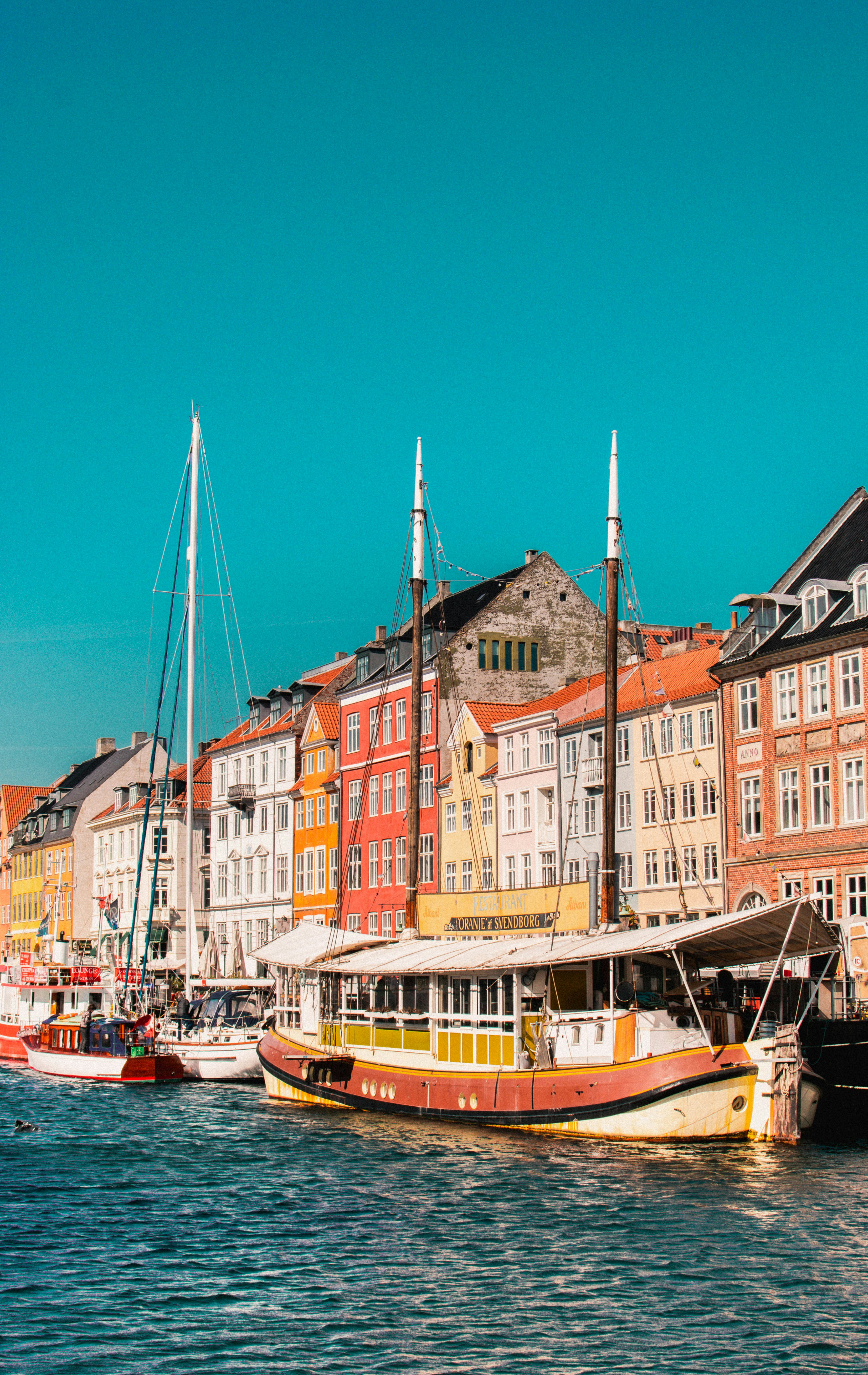 boats on harbor in front of building