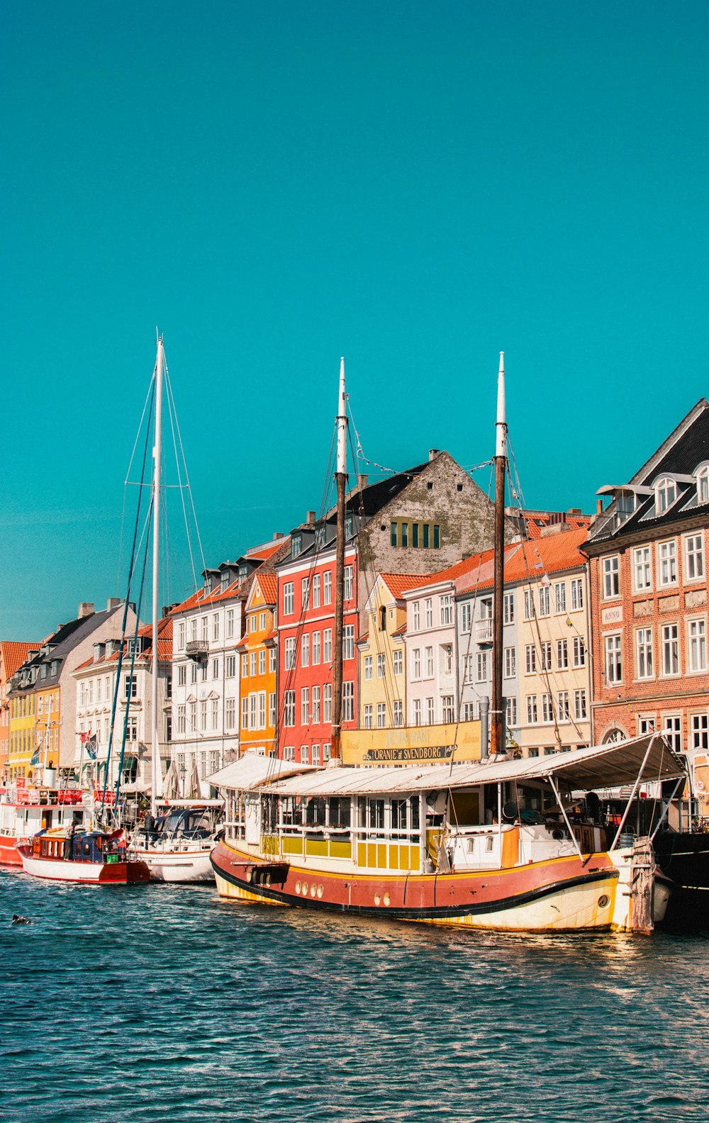 boats on harbor in front of building