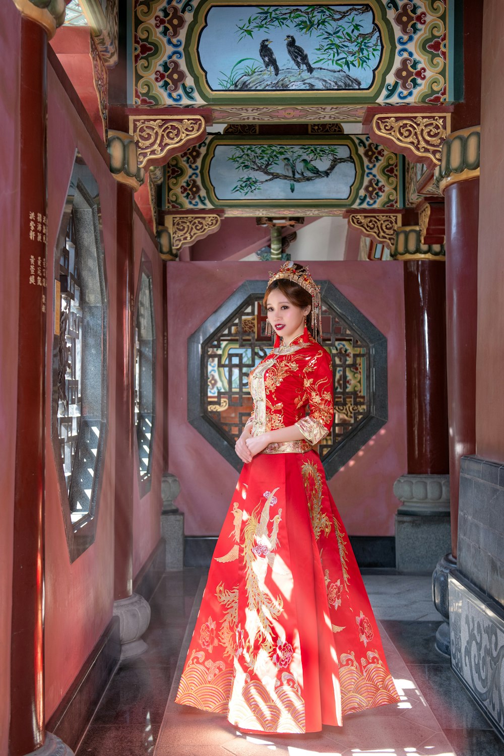 woman wearing red and gold Chinese dress