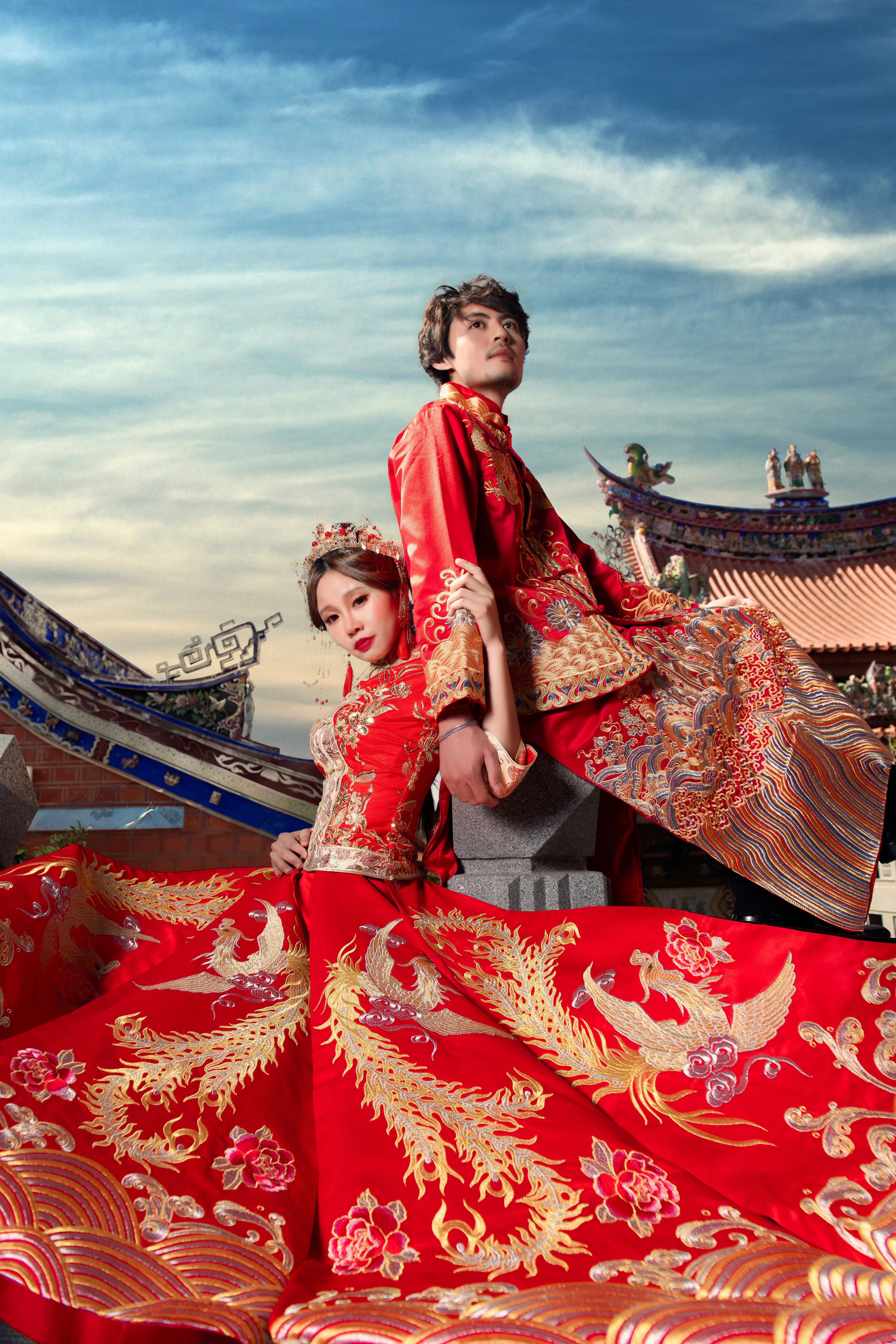 man and woman in red-and-gold wedding suits