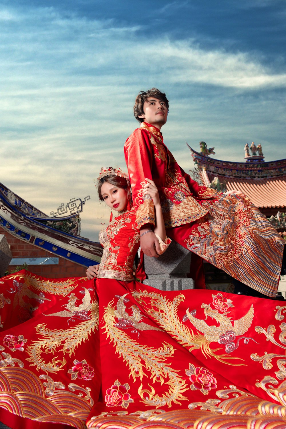 man and woman in red-and-gold wedding suits