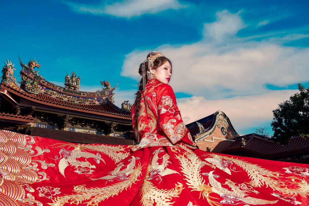 woman in red and brown floral dress posing outdoors