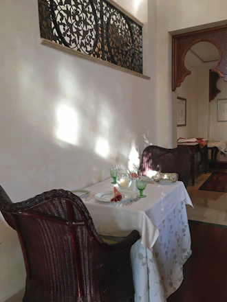 Elegant table set for a private dinner in a sunlit Andalusian villa terrace.