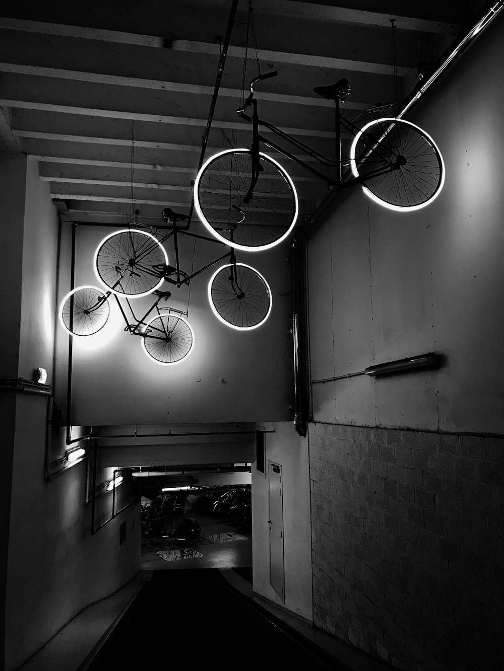 classic bikes with lighted wheels hanging on ceiling