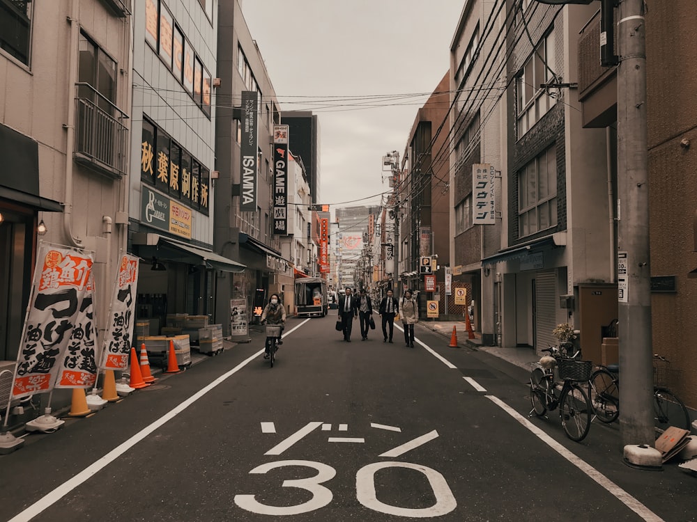 people walking in road during daytime