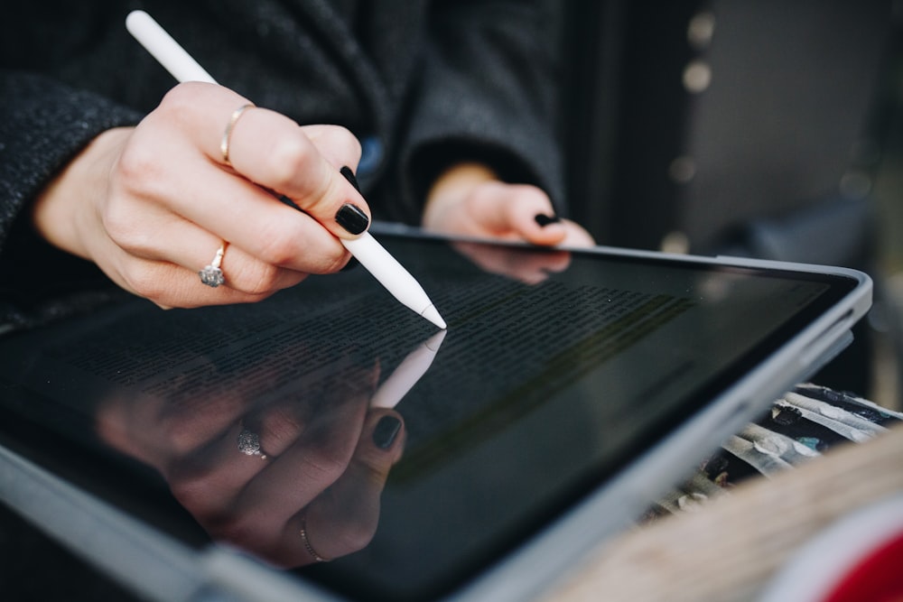 man holding Apple pencil