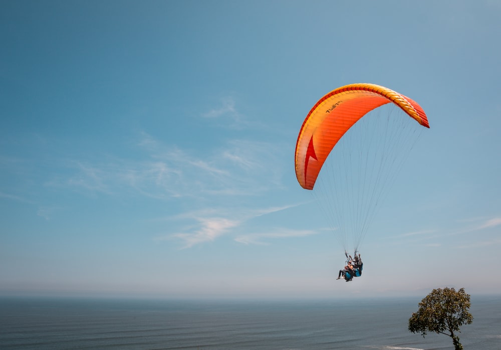 person riding on parachute during daytime