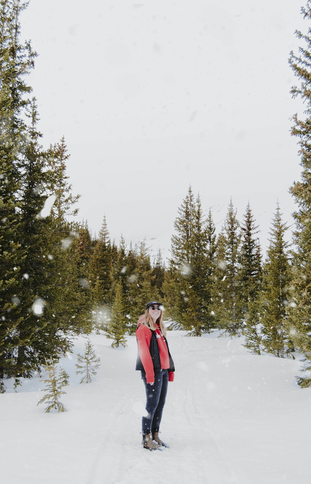 woman in red top and black jeans on snow field