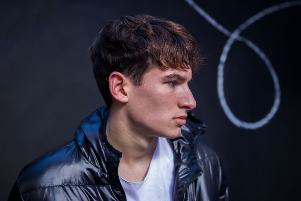 man wearing black leather hooded jacket