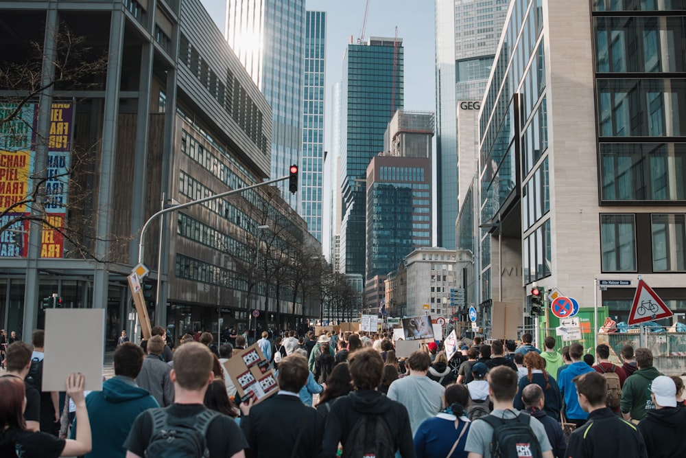 crowd on street between buildings