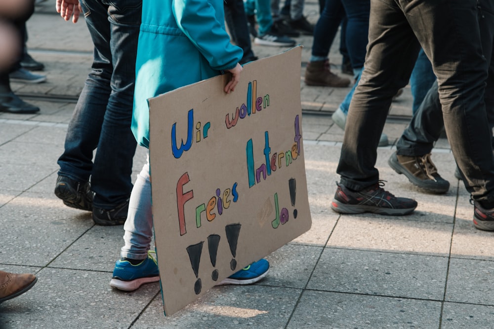 person holding cardboard signage