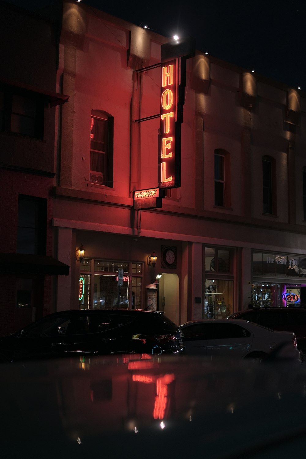 cars parked near hotel during nightime