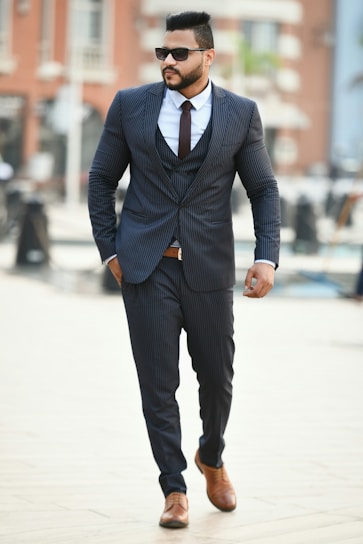 A stylish man walking confidently in a modern urban setting