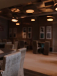 An intimate shot of a cozy restaurant interior with soft lighting, alongside a candid photo of the team setting up a food shoot.