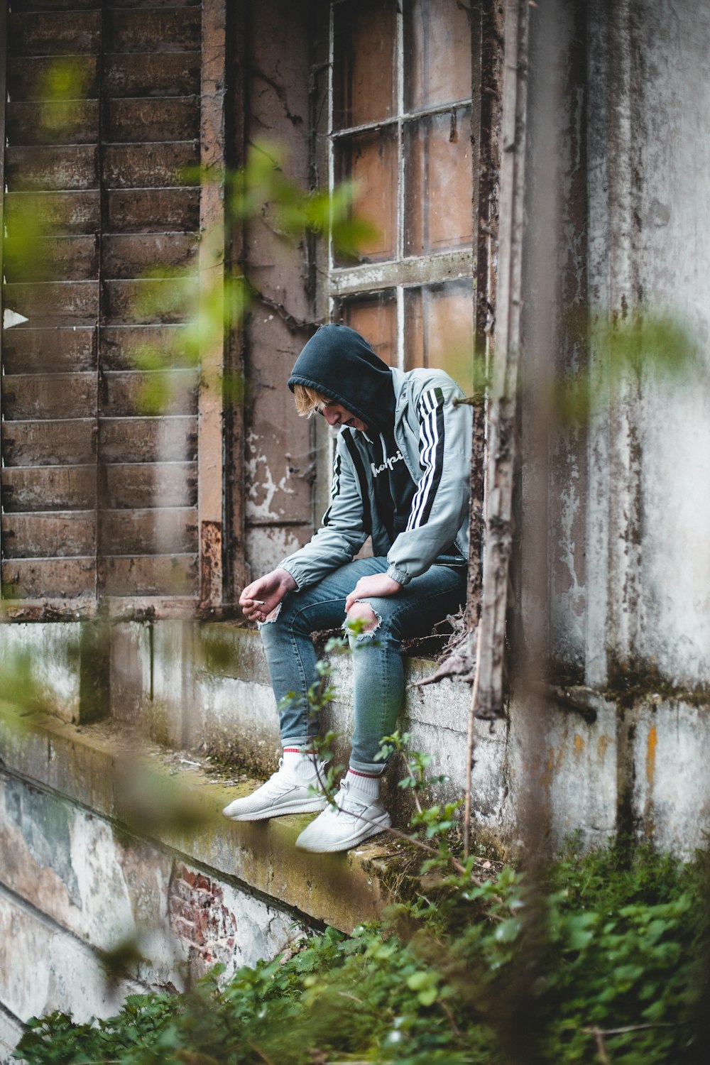 man sitting outside the window