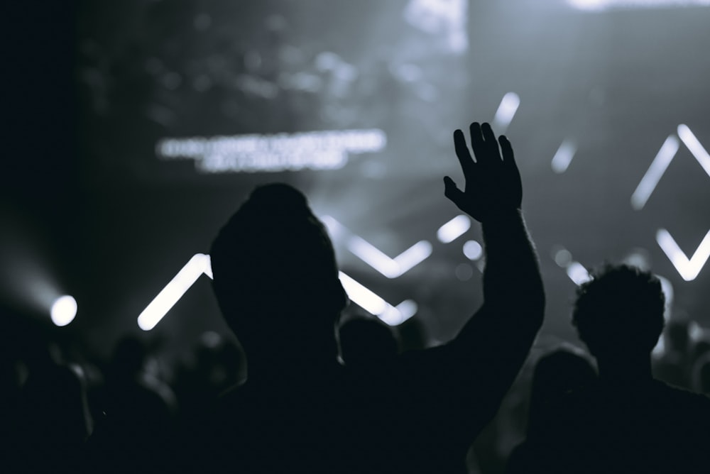 silhouette of people in front of stage