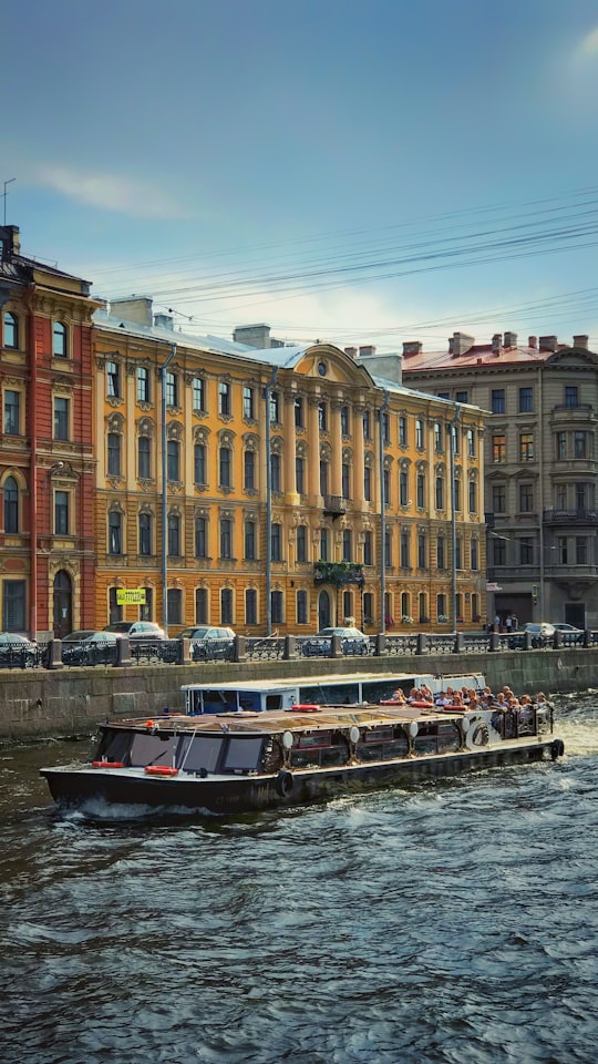 brown boat near brown building in embankment river Moyka Russia