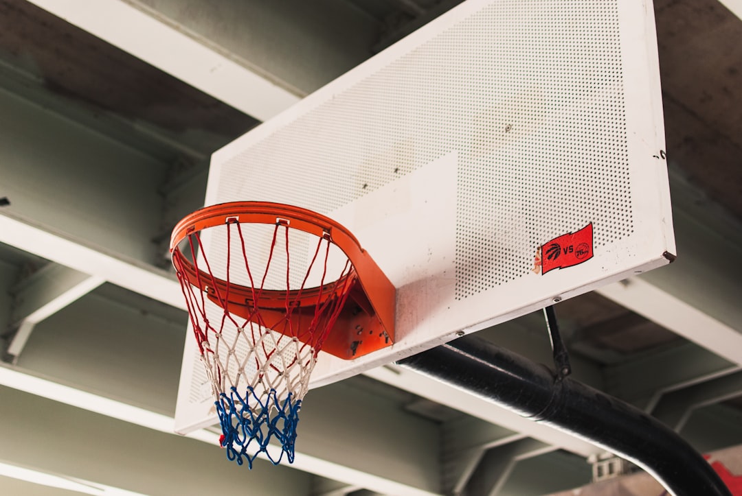 white and red basketball hoop on focus photography