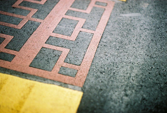 a close up of a red and yellow line on the ground