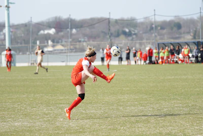 Close-up of a soccer player mid-kick with intense focus during a live match.