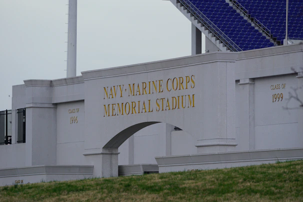 The historic entrance of نادي الميناء الرياضي stadium with the club’s emblem prominently displayed.