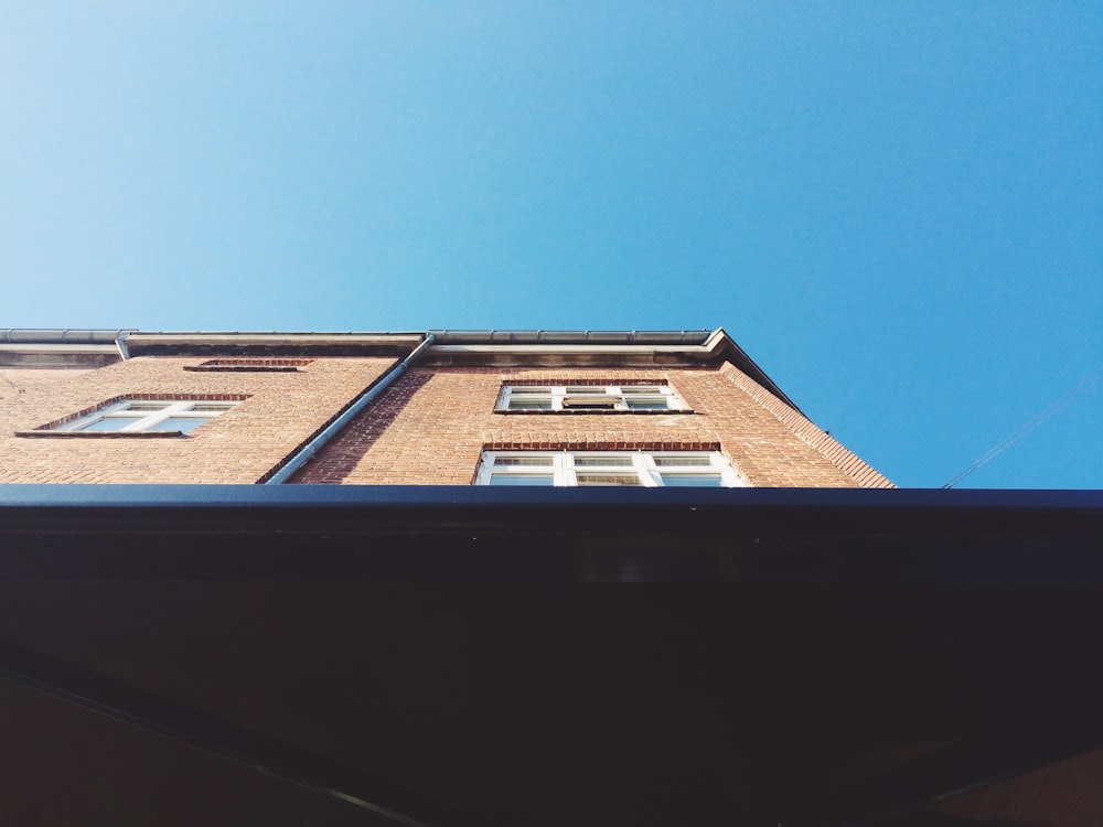 looking up at a tall brick building from below