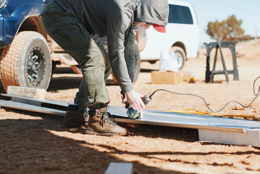 person standing and using angle grinder