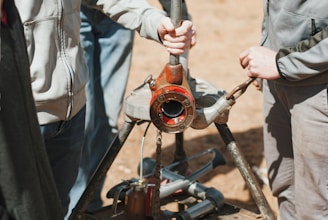 a man holding a wrench while standing next to another man