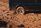 black car stuck on mud
