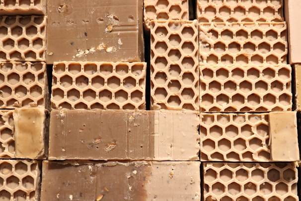 Close-up of natural wax blocks stacked neatly on a wooden table.