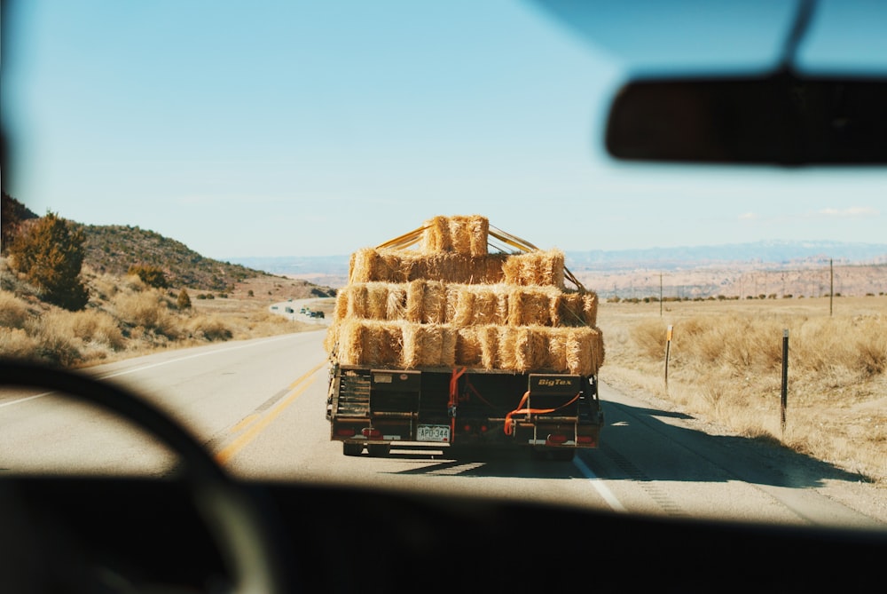 a truck is loaded with hay on the side of the road