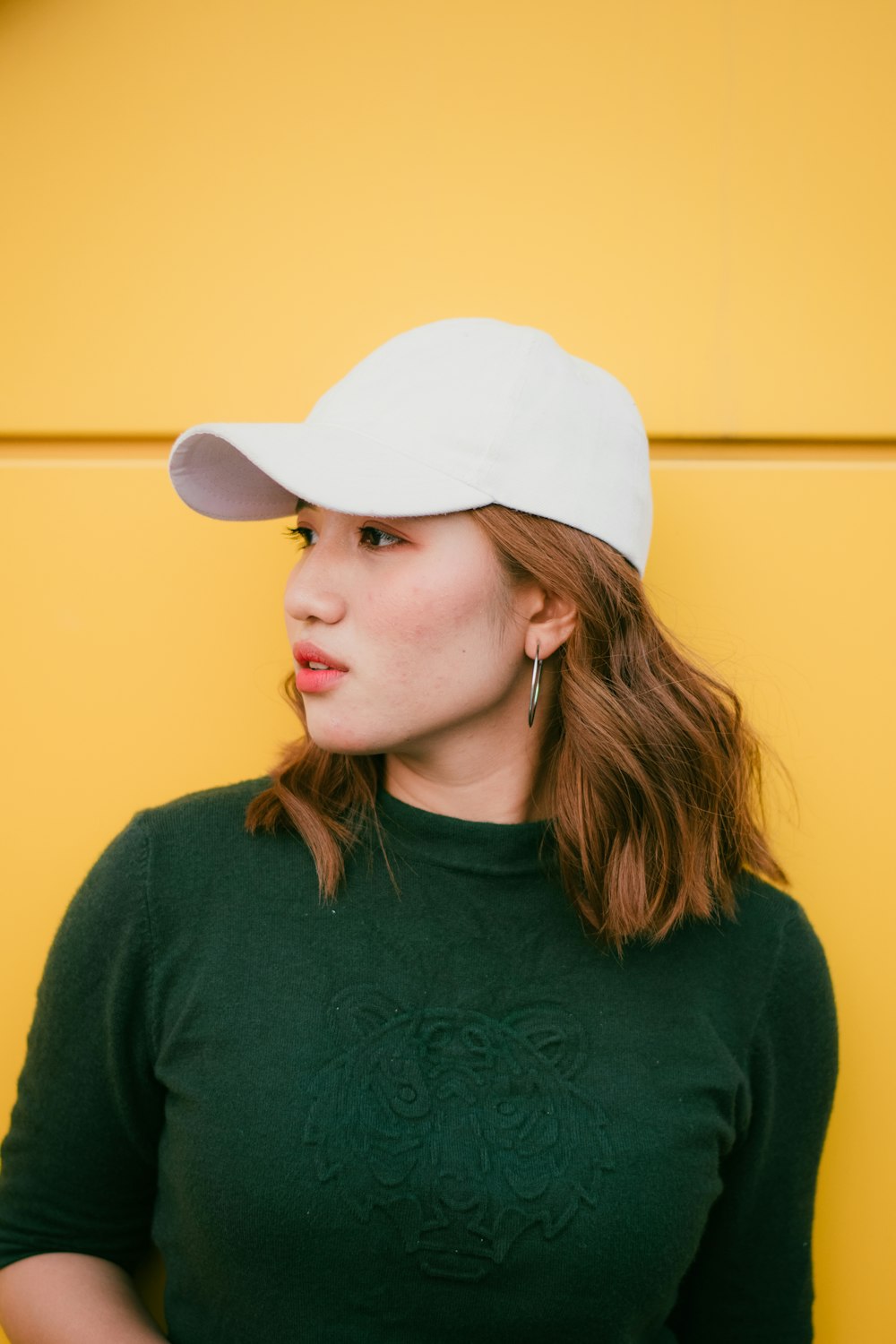 woman standing near yellow wall