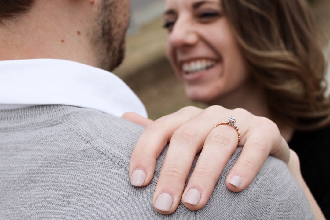 smiling woman grabbing man's shoulder