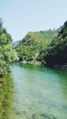 A tranquil river flowing gently near the resort with hills in the background.
